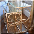 F08. Pair of metal glass top nesting tables. 24"h x 24"w x 14"d 